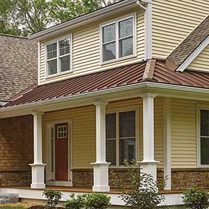 Front view of typical two-story mid-class home with beige CertainTeed siding