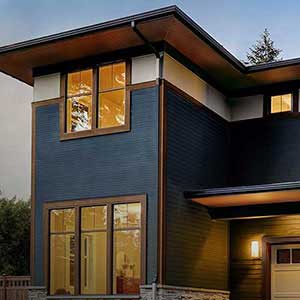 Front view of a high-end two-story home with dark blue Mastic siding